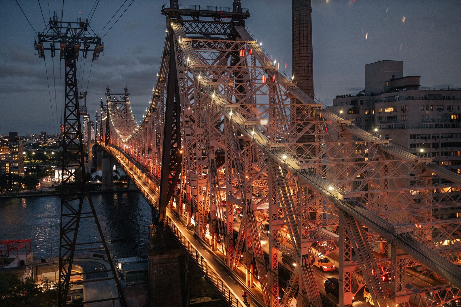 The Queensboro Bridge and the Roosevelt Island tram lit up at dusk